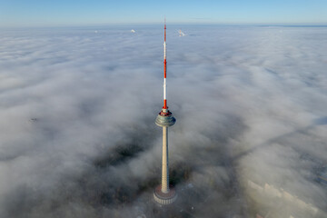 Aerial autumn morning view of Vilnius TV Tower in fog, Lithuania