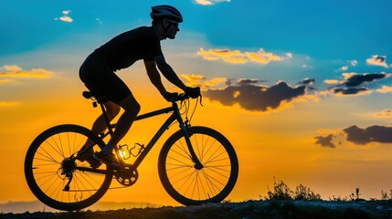 Naklejka premium Silhouette of a cyclist riding a bike at sunset.