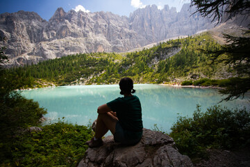Fototapeta premium Travel woman man hiker at Sorapis Lake in the Dolomite Mountains