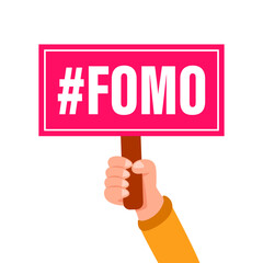 Hand holding a sign with fomo fear of missing out acronym on it