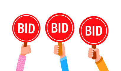 People holding bid paddles making offers at an auction