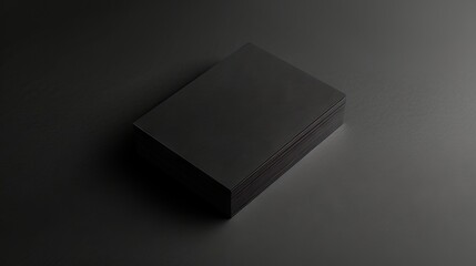 Professional business card with sleek, minimalist design and elegant typography elegantly placed on a smooth black background, ideal for corporate branding, networking, and marketing purposes