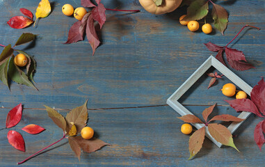 Frame of fall leaves, fruits on wooden board. Holidays and food. Background for design. 