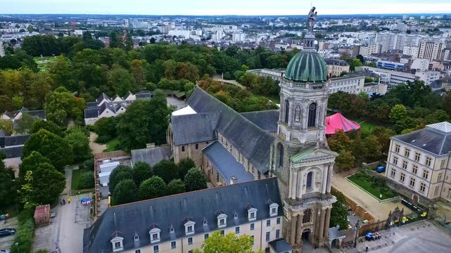 Approaching movement towards the abbey church of Notre-Dame-en-Saint-Melaine with Thabor Park, Rennes, France.