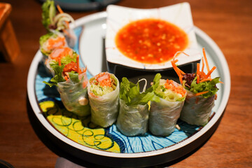 Goi cuon tom thit or Vietnamese summer rolls with shrimp. Cooked prawns or shrimp are wrapped in rice paper with fish mint leaves, bean sprouts, lettuces, mints, and noodles. Dip in cured fish sauce