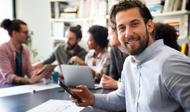 Team of multiethnic diverse young software developers talk, discuss an AI project. Business startup