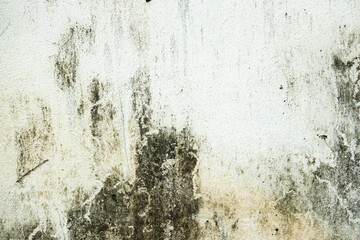 A wall with a lot of dirt and grime on it. The wall is white and the dirt is black