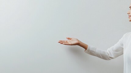 Elegant Woman's Hand Gesturing Towards a Whiteboard
