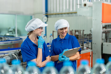 Obraz premium Caucasian female industry worker team working in factory warehouse.