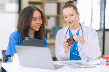 Two female scientists work in a laboratory with blood samples and test tubes filled with solution...