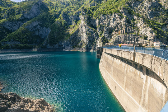 Mratinje hydroelectric power dam in the narrow gorge of Piva river in Montenegro or Crna Gora. Wide panoramic view of deep gorge behind the high concrete dam...