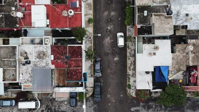 Drone footage of car avoiding potholes on streets of Ecatepec, CDMX, Mexico