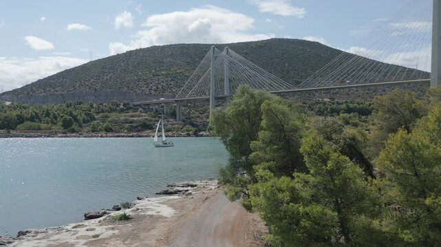 Reveal the hight bridge in Chalkida as passing a yacht
