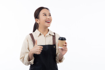 Fototapeta premium Cheerful young asian woman barista in casual work attire happily holding a takeaway coffee cup while thumbs up isolated white background, barista presenting takeaway coffee, small business or startup.