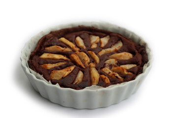 Homemade Chocolate tart with sweet pear fruits in a bake pan isoalted on white background
