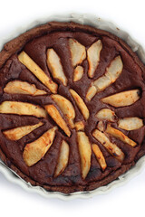 Top view of homemade Chocolate tart with sweet pear fruits in a bake pan isolated on white background