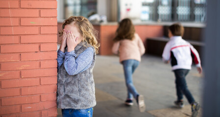 Children playing hide and seek in the schoolyard