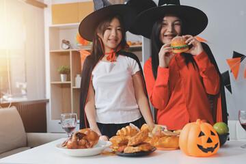 Fototapeta premium friendship, holiday and people concept - group of happy smiling friends in halloween costumes of vampire, devil, witch and cheetah at home party
