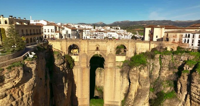 Ascending forward flying drone shot of Ronda City in Spain, Europe. Arch bridge, homes, streets are located on the rocky cliff. High quality 4k prores footage.