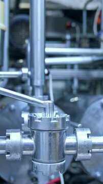 Dairy factory with milk pasteurization tank and pipes. Motion camera view Vertical video