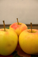 Red and yellow apple on glass dish / plate.