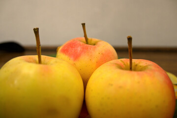 Red and yellow apple on glass dish / plate.