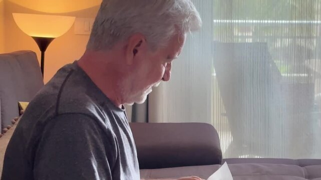 Witness the heart-wrenching moment of an elderly man in his home, overcome with tears as he sits on the sofa. The film explores the deep sadness and loneliness faced by a widower dealing with loss and