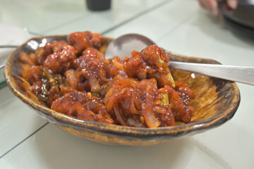 Spicy Indian cabbage with gravy served in bowl in restaurant.