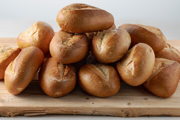 pile of fresh buns on display at bakery, close-up