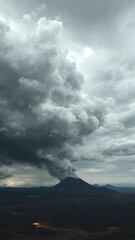A dramatic sky filled with dark clouds of volcanic ash, with fiery orange tones visible near the horizon as lava flows in the distance
