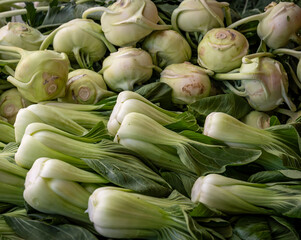 A display of Bok choy and Kohlrabi in a farmers' market.