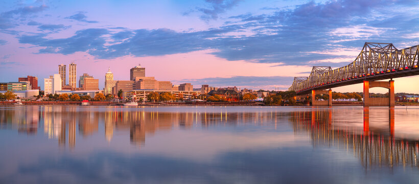  Peoria, Illinois, USA. Panoramic cityscape image of Peoria skyline, Illinois, USA with reflection of city lights in the Illinois River at autumn sunrise.