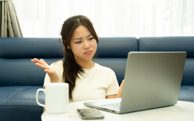 Portrait of young Asian girl using laptop and drink coffee ,  at home