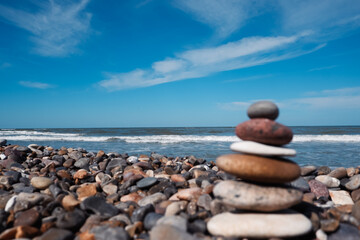 Balanced stones on a pebble beach. Background peaceful meditation and mindfulness. Mental health and meditation concept.