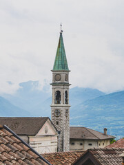 Fototapeta premium Catholic church of an italian village surrounded by mountains
