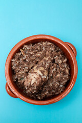 Typical portuguese dish chicken with rice in ceramic dish.