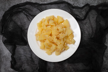 Boiled potatoes, in small cubes on white plate