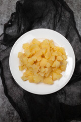 Boiled potatoes, in small cubes on white plate