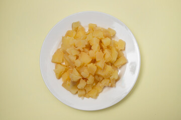 Boiled potatoes, in small cubes on white plate