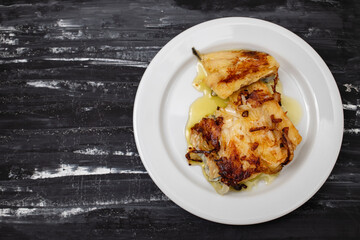 fried cod fish with olive oil on white dish