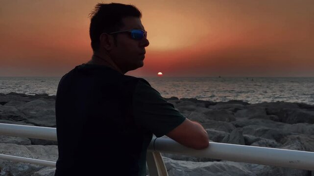 A young Man Enjoy Sunset At Dubai Palm PlamJumeirah
