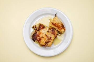 fried cod fish with olive oil on white dish