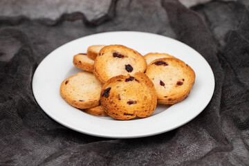 Freshly baked rusks with raisins, on small plate