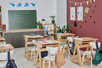 No people wide shot of modern school classroom interior prepared for vocational guidance day, copy space