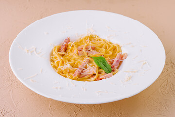 Carbonara pasta dish with ham and parmesan cheese