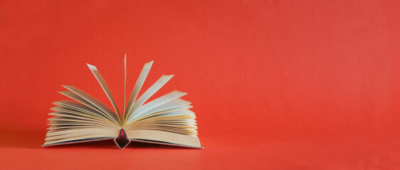 Open book, Reading, learning, education or home office business concept.Red background, free copy...