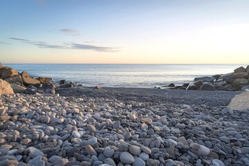 a pebble beach with a vast sea in the background