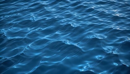 Obraz premium Rippling blue water surface with light reflections, creating a dynamic and abstract pattern