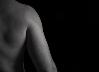 Fototapeta premium Attractive sensual man posing and showing off his muscular back, fitness and workout concept, copy space