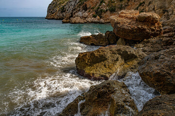 The Granadella cove with crystal-clear waters in Javea, Alicante, in the Spanish Mediterranean